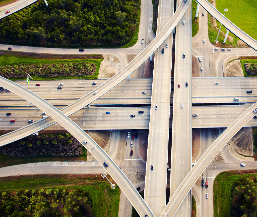 Aerial view of multiple highways crisscrossing each other andcars driving on them